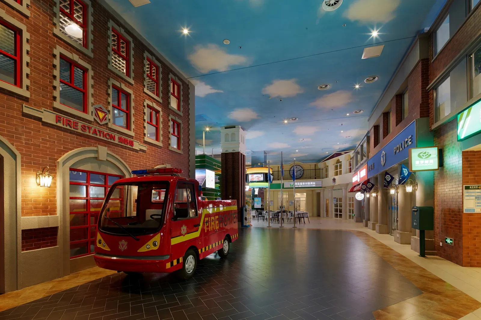 Fire station facade with a child-size fire engine on the street