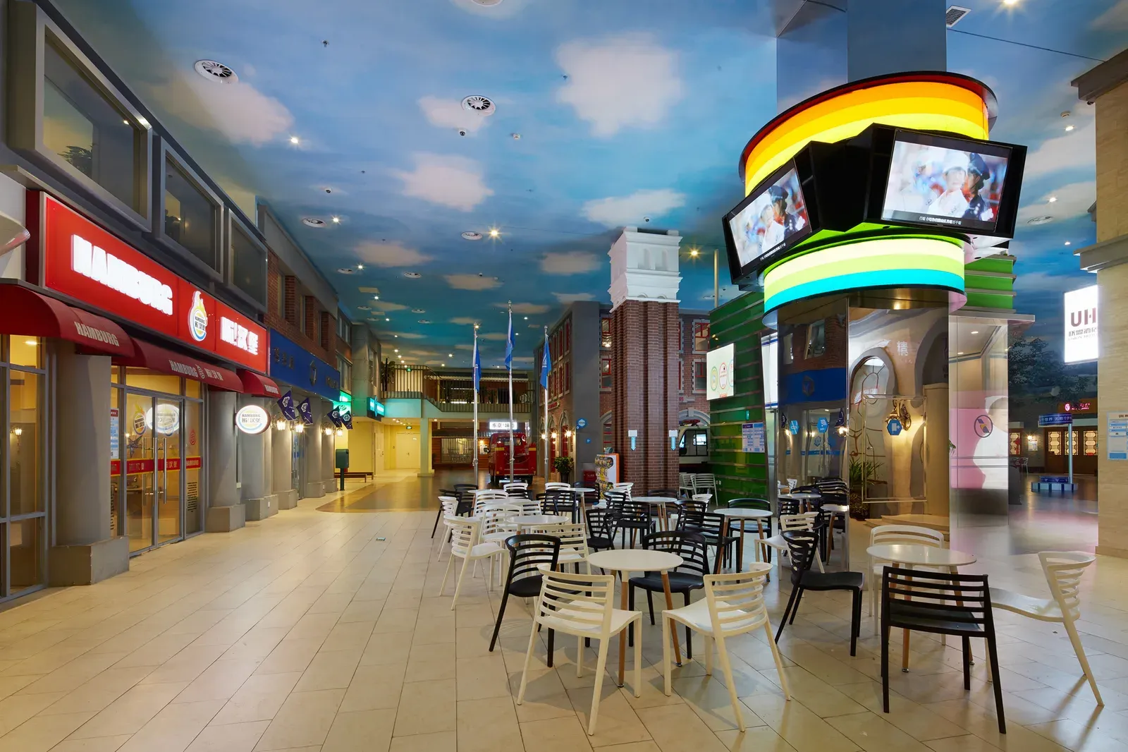 Café seating beside a curved information kiosk