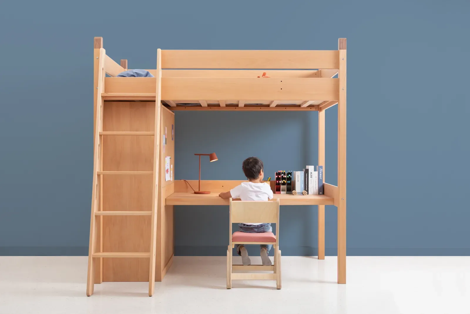 Timber loft bed with ladder, storage and desk below
