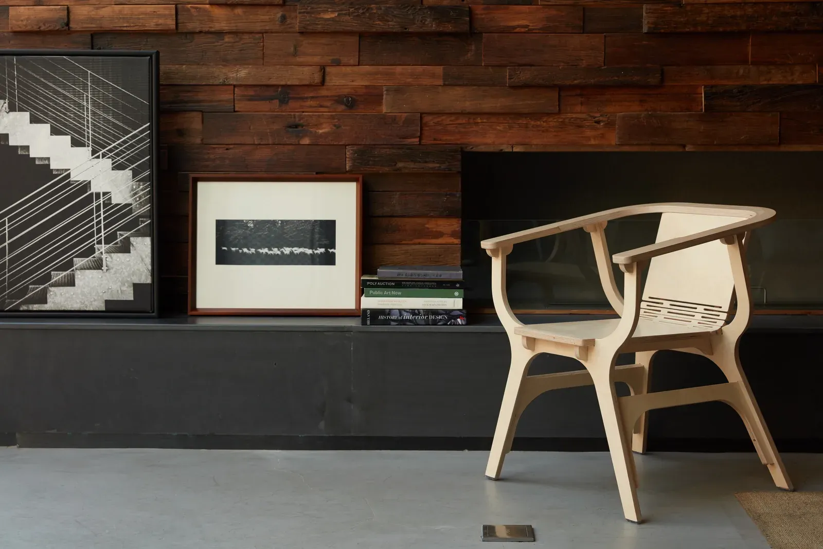 Plywood armchair in a dark timber-lined interior