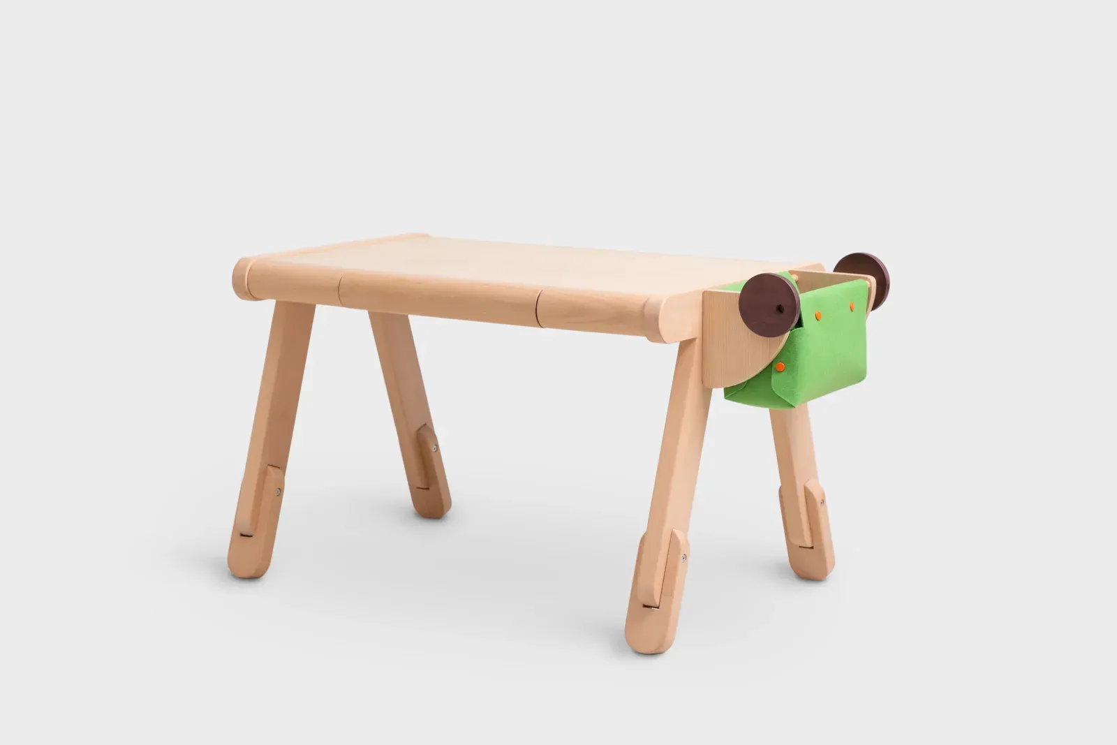 Children’s table with a green fabric storage pocket