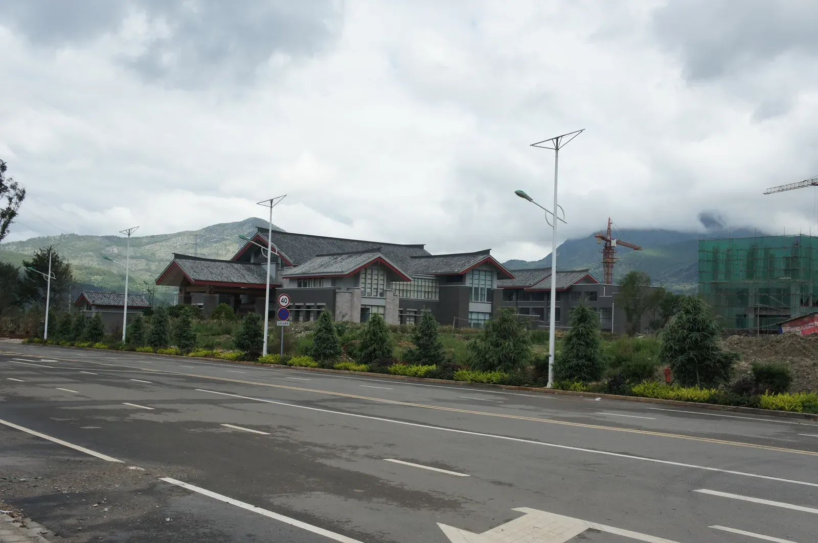 Existing buildings near the site, with mountains behind